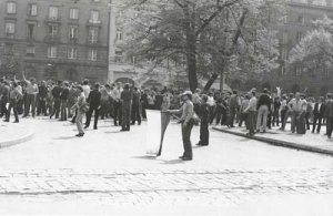 A group of demonstrators present at the streets of Wrocław. In front of the crowd, there stands an unknown man with a flag in his hand.